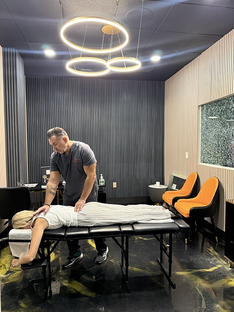 Dr. Arthur Vito adjusting a patient on the treatment table